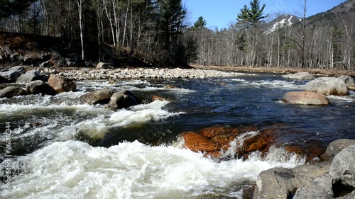 Pure running water of a river in the wilderness photo