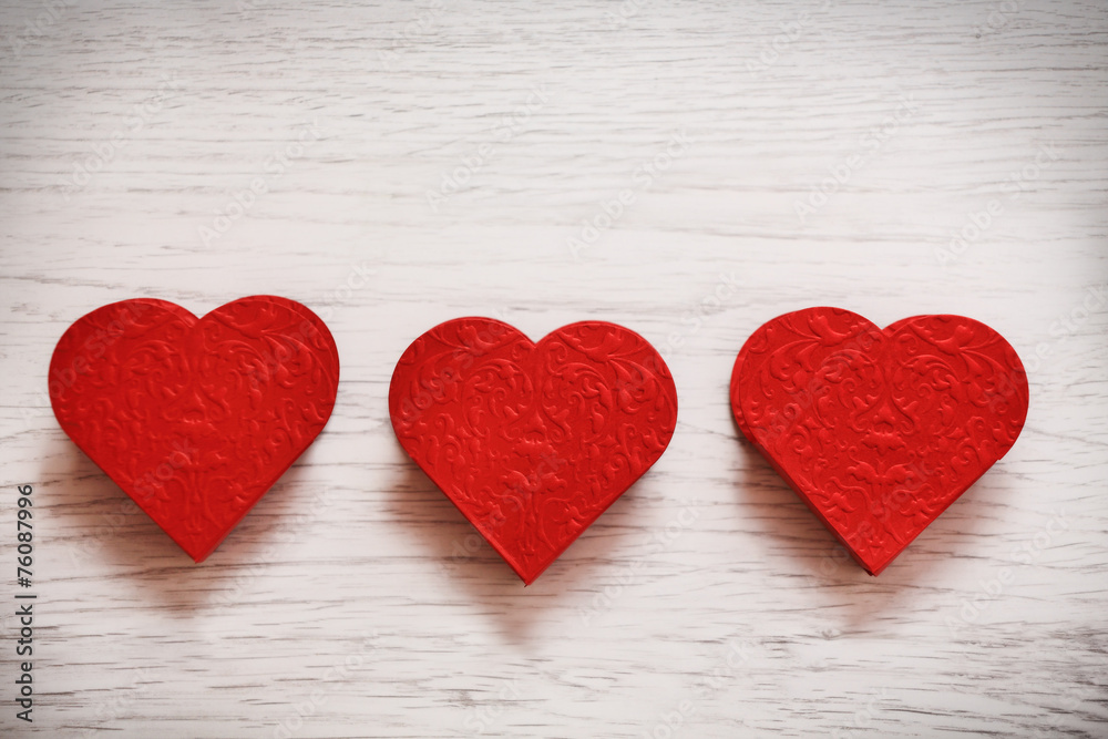 valentines day background with three hearts on wooden background valentines day background with three hearts on wooden background