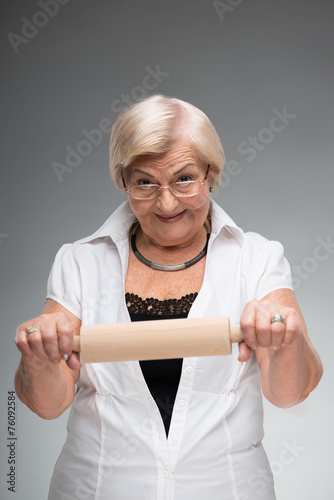 Elderly woman with rolling pin