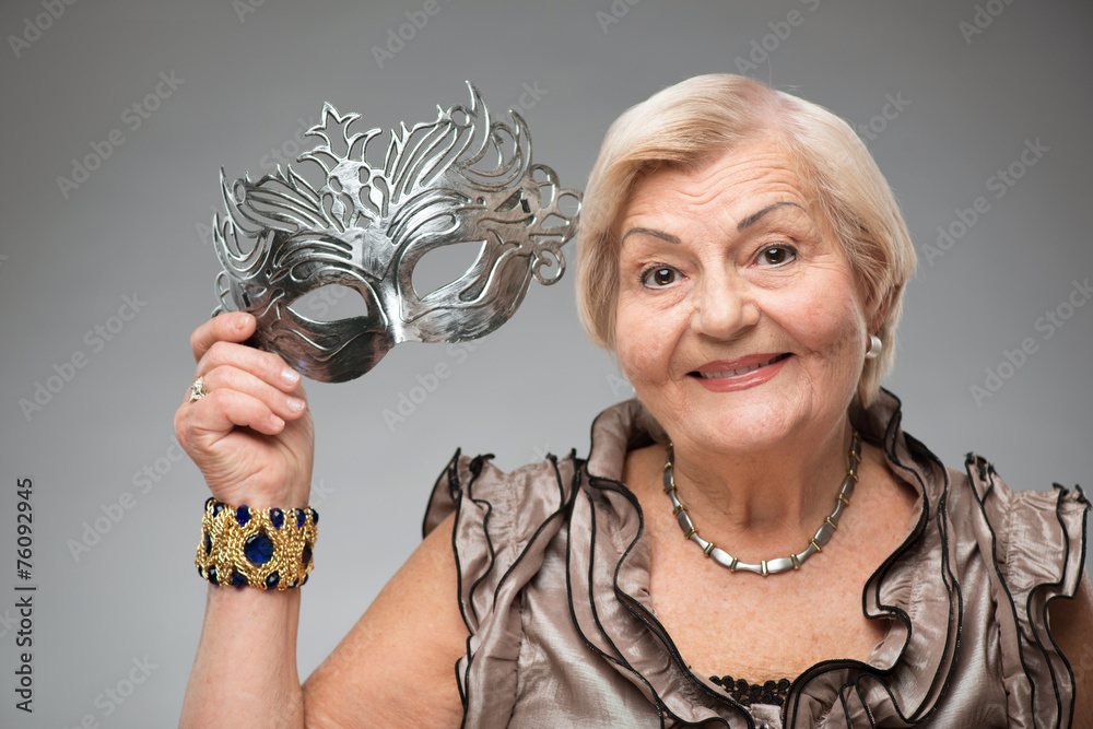 Elderly woman wearing glamorous mask - obrazy, fototapety, plakaty 