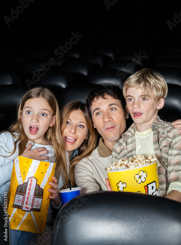 Surprised Family Watching Movie In Theater