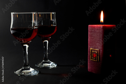 Beautiful Red Candle and Two Glass Cups of Red Wine Isolated