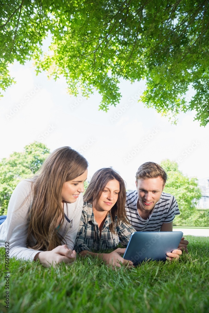 Fototapeta premium Happy students using tablet pc outside