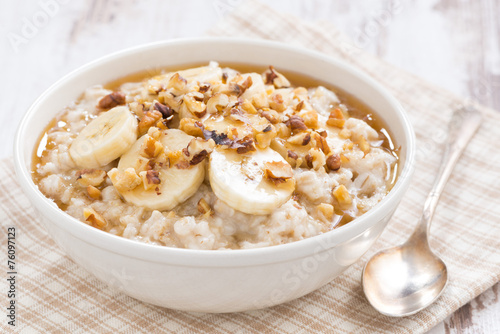 oatmeal with banana, honey and walnuts in bowl