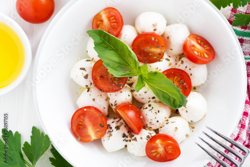 salad with mozzarella, basil and cherry tomatoes in bowl