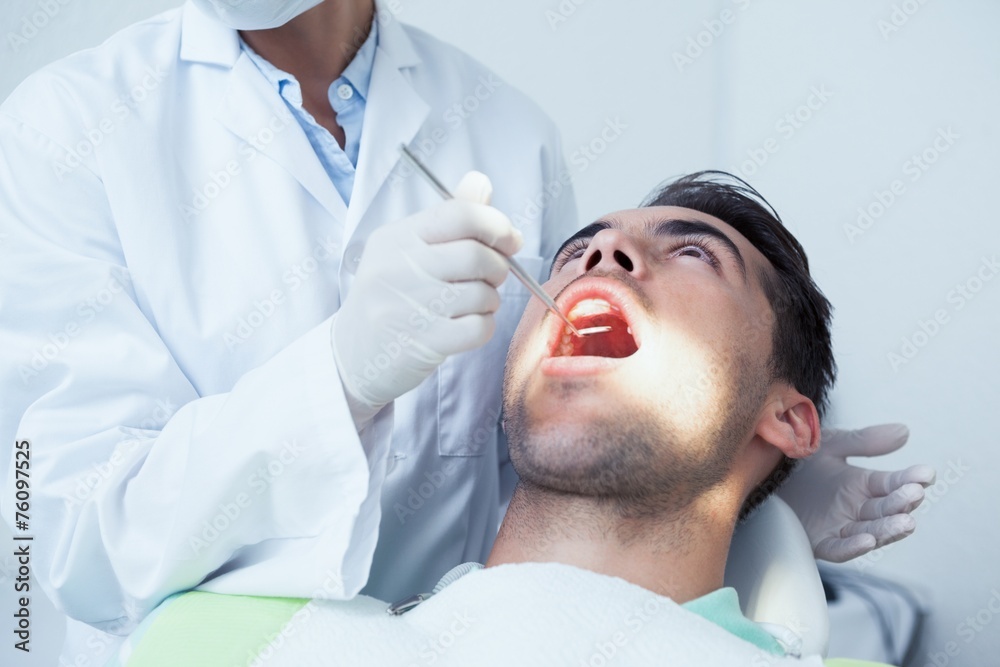 Close up of man having his teeth examined Close up of man having his teeth examined