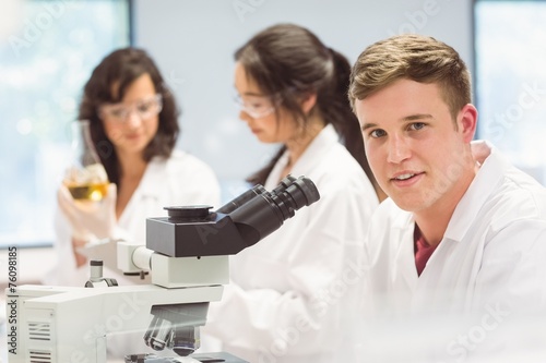 Science student looking through microscope in the lab