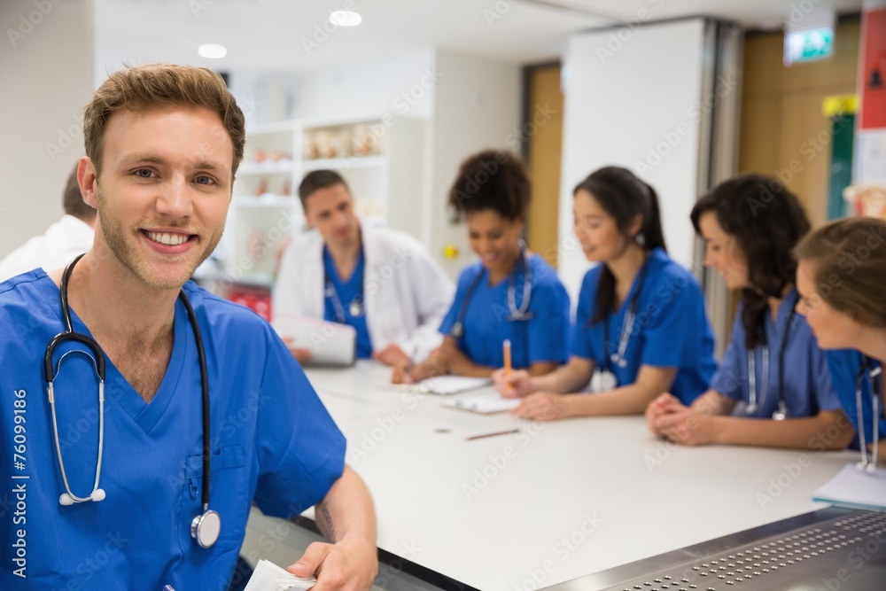 Medical student smiling at the camera during class Medical student smiling at the camera during class