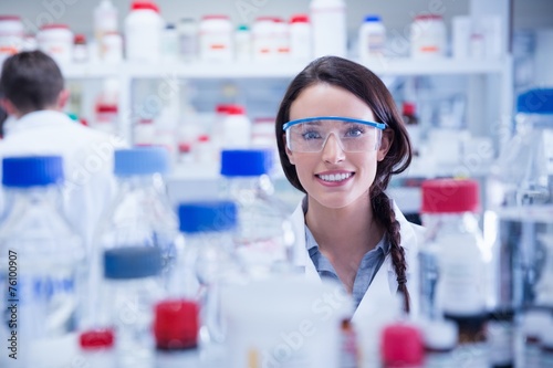 Portrait of a smiling chemist wearing safety glasses