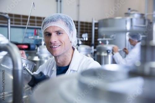 Close up of a man wearing a hair net looking at the camera