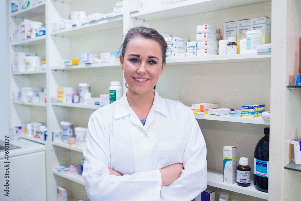 Portrait of a smiling student in lab coat with arms crossed