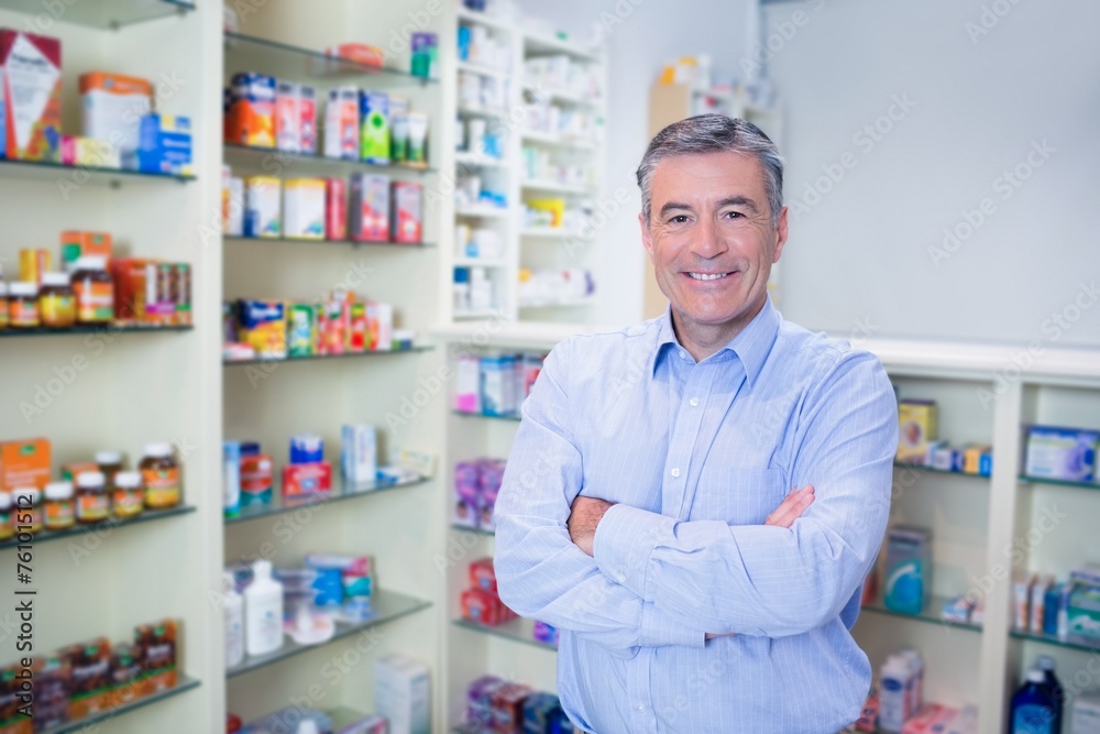 Portrait of a smiling pharmacist standing with arms crossed