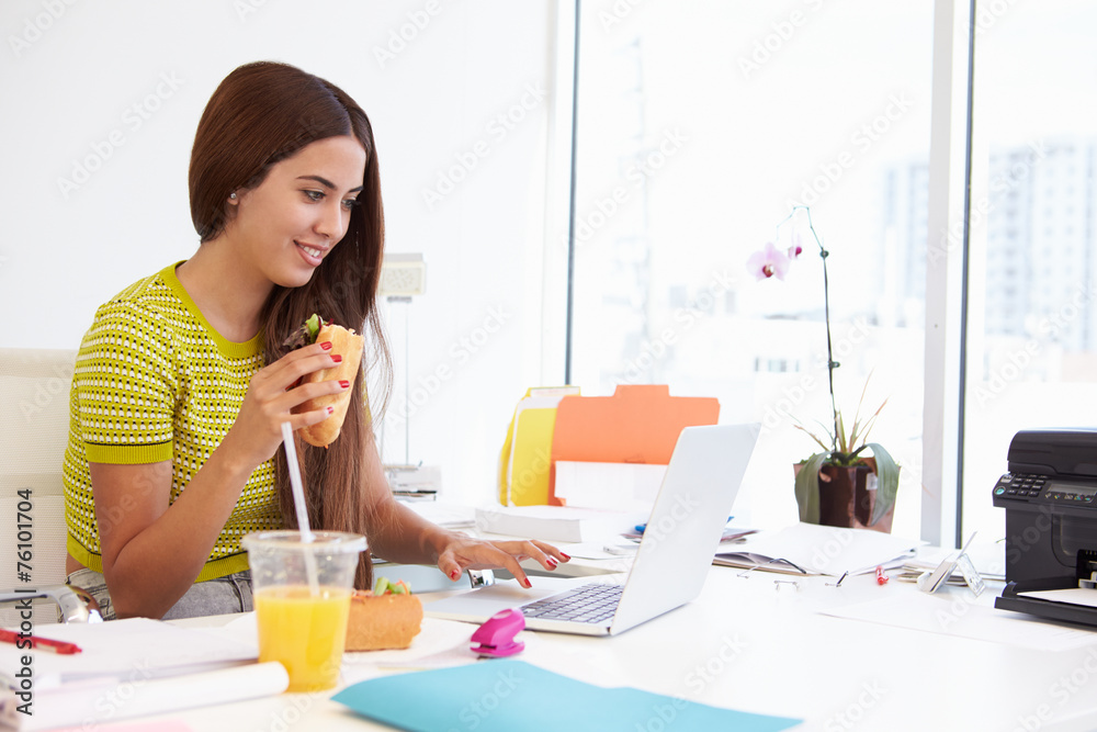 Woman Working In Design Studio Having Lunch At Desk Woman Working In Design Studio Having Lunch At Desk