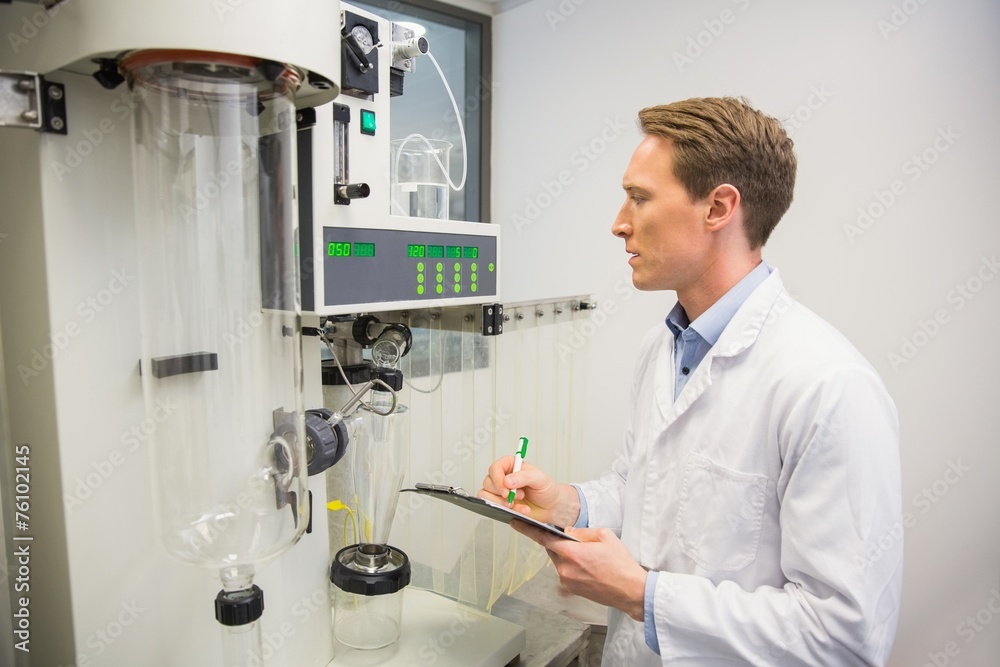 Pharmacist using machinery to make medicine Pharmacist using machinery to make medicine