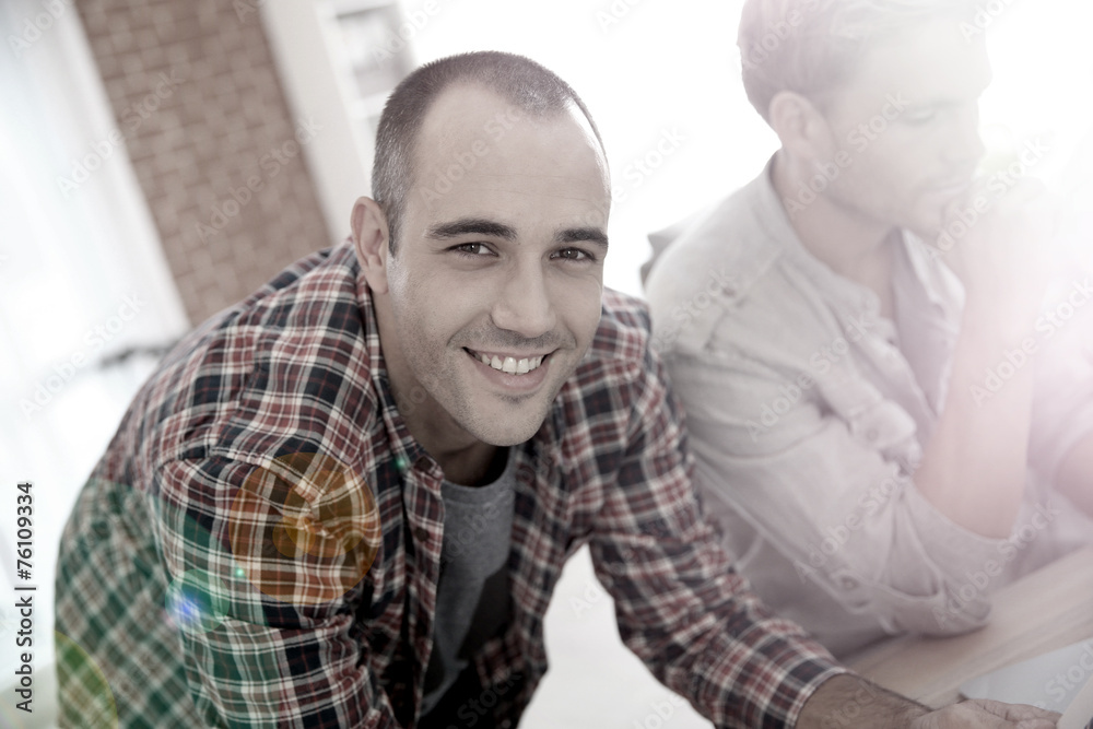 Smiling guy in shared apartment with roommates Smiling guy in shared apartment with roommates