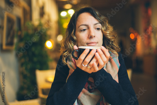 woman with smart phone in coffee shop