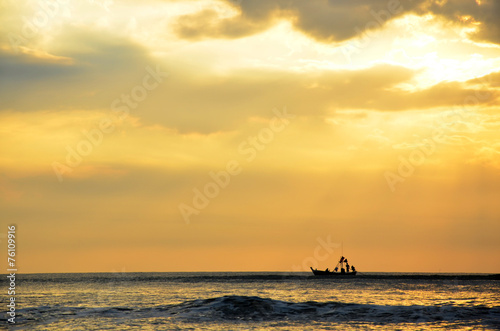 Fishing boat floating on the sea in morning and sunrise time
