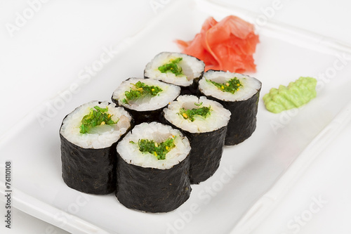 Sushi roll with fish and green salad.