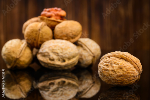 Walnuts on old wooden background