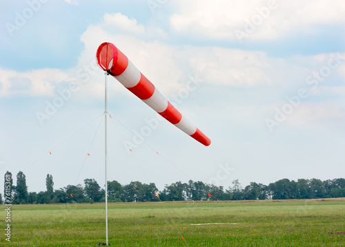 Windsock against cloudy sky.