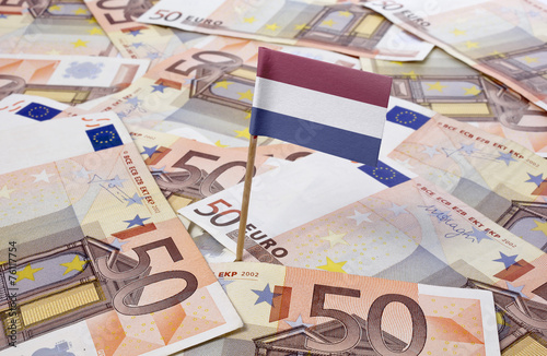 Flag of Netherlands sticking in 50 Euro banknotes.(series) photo