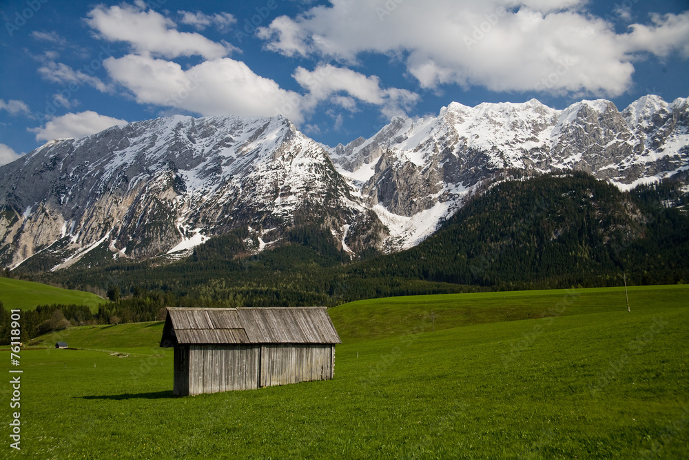 Small farmer hut with snowy mountains in the back Small farmer hut with snowy mountains in the back