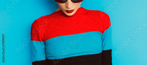 sensual fashion girl on blue background. Red lipstick trend photo