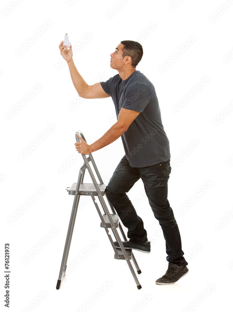 Man Climbs Stepladder To Replace Light Bulb Man Climbs Stepladder To Replace Light Bulb
