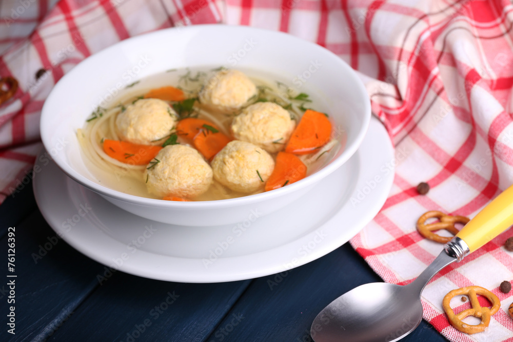 Soup with meatballs and noodles in bowl on wooden background Soup with meatballs and noodles in bowl on wooden background
