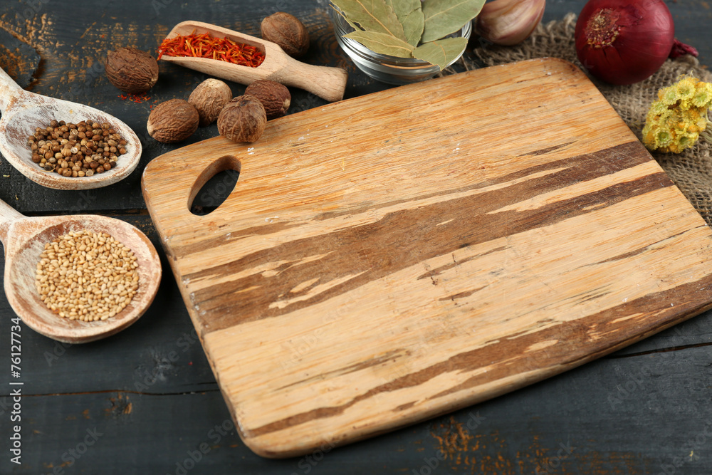 Different spices and herbs with cutting board Different spices and herbs with cutting board