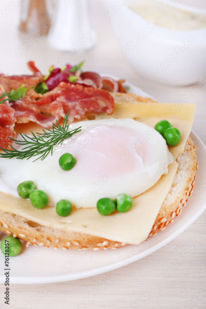 Sandwich with poached egg, cheese and bacon