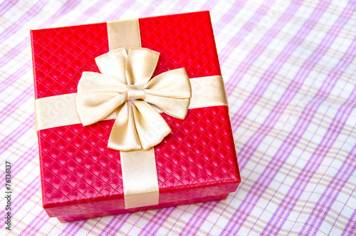 red gift box with gold ribbon