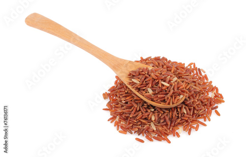 Red rice in a wooden spoo photo