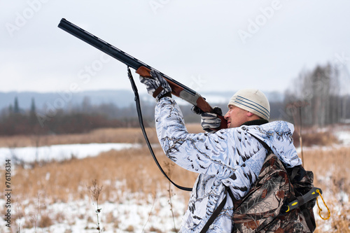 hunter shooting on the snowy field