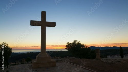 Huge cross against the background of a sunrise