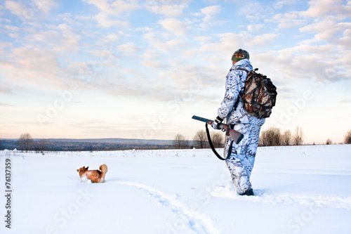 hunter with a dog on a frosty day