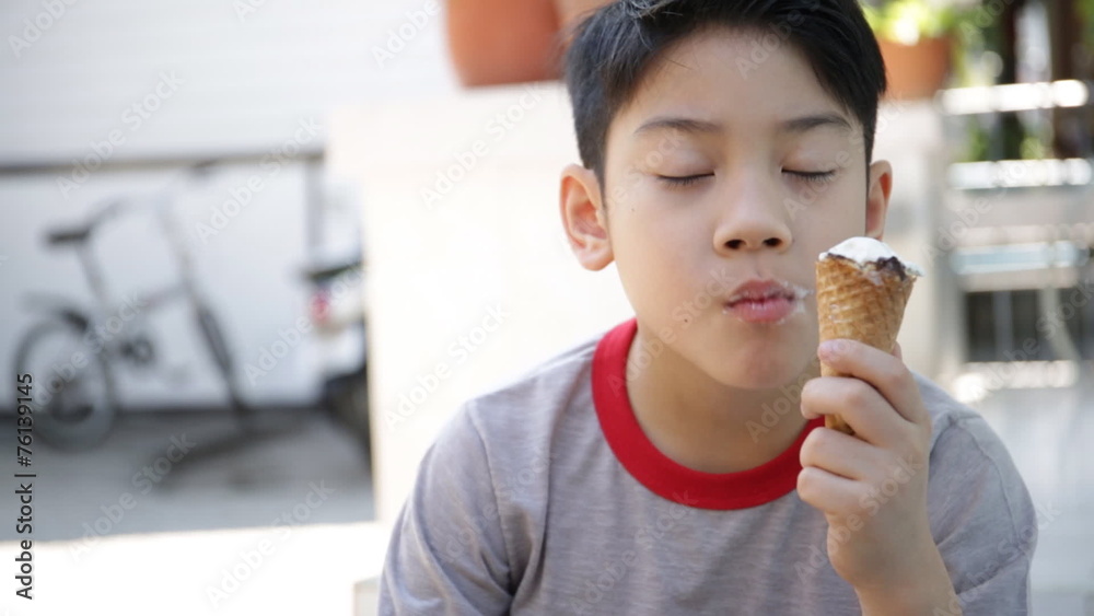 Asian kid enjoy delicious ice cream cone during the summer. Asian kid enjoy delicious ice cream cone during the summer.