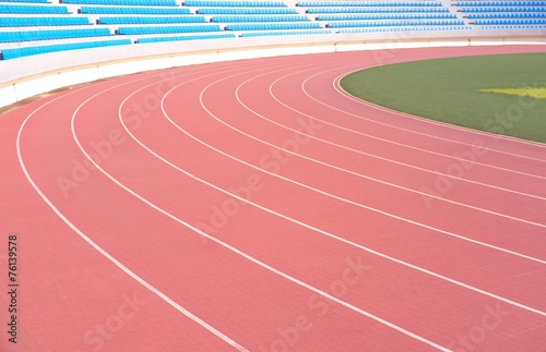 Athletic running track with stadium seats in background