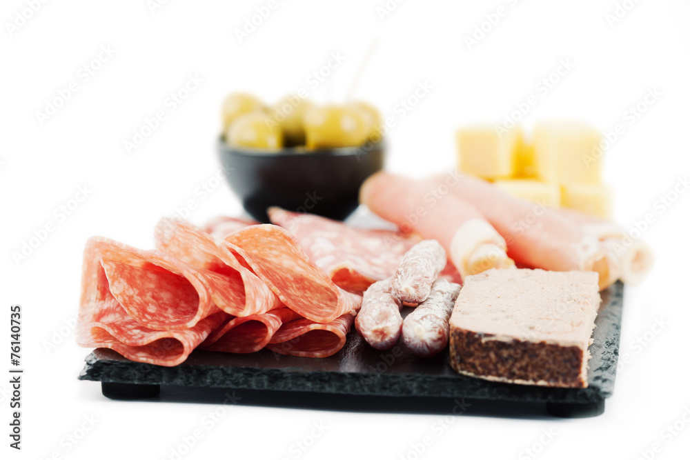 Charcuterie assortment and olives on white background