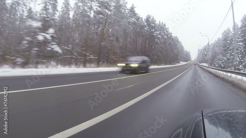 winter  highway in wood. Ukraine. POV   view
