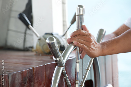 Hands hold steering wheel the boat