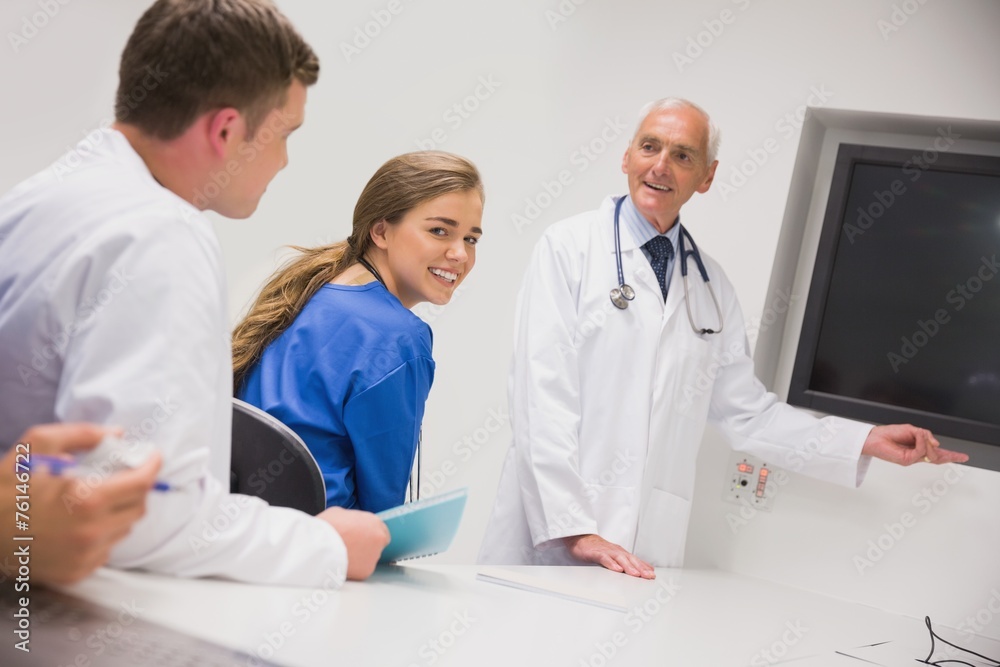 Medical professor teaching young students Medical professor teaching young students