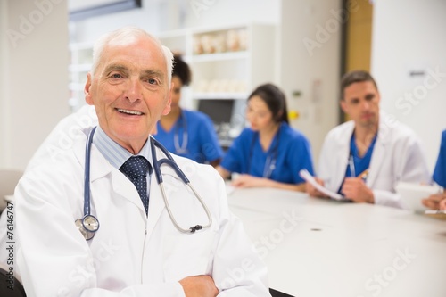 Medical professor smiling at the camera during class