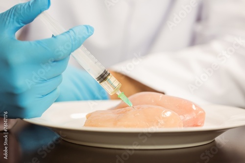 Photos Food scientist injecting raw chicken