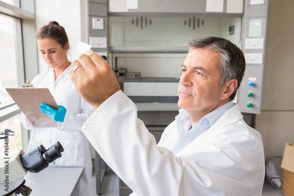 Senior scientist looking at slide Senior scientist looking at slide