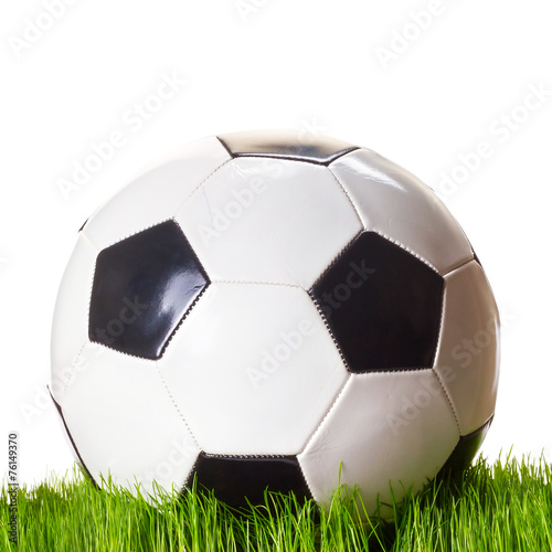 Soccer ball on grass over white background