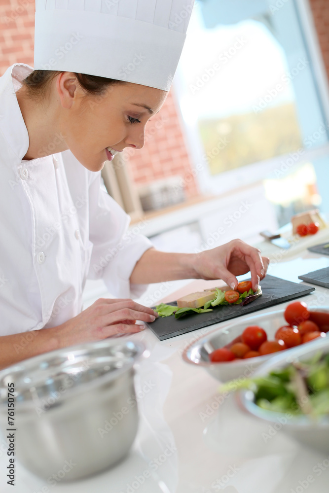 Smiling cook preparing appetizer Smiling cook preparing appetizer