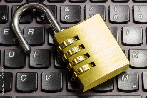Open combination padlock on a keyboard symbolizing data security