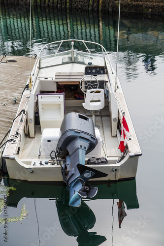 Black Motor on White Boat with Canadian Flag