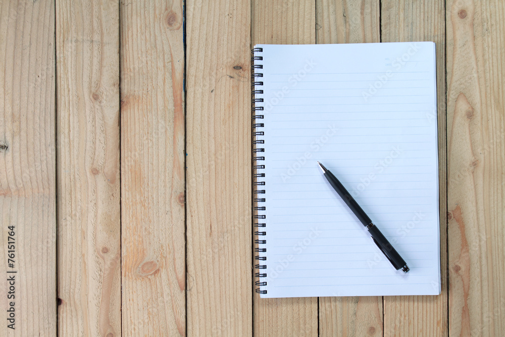notebook on wood background notebook on wood background